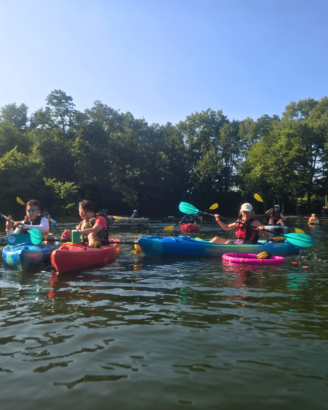 Several participants kayaking on a lake