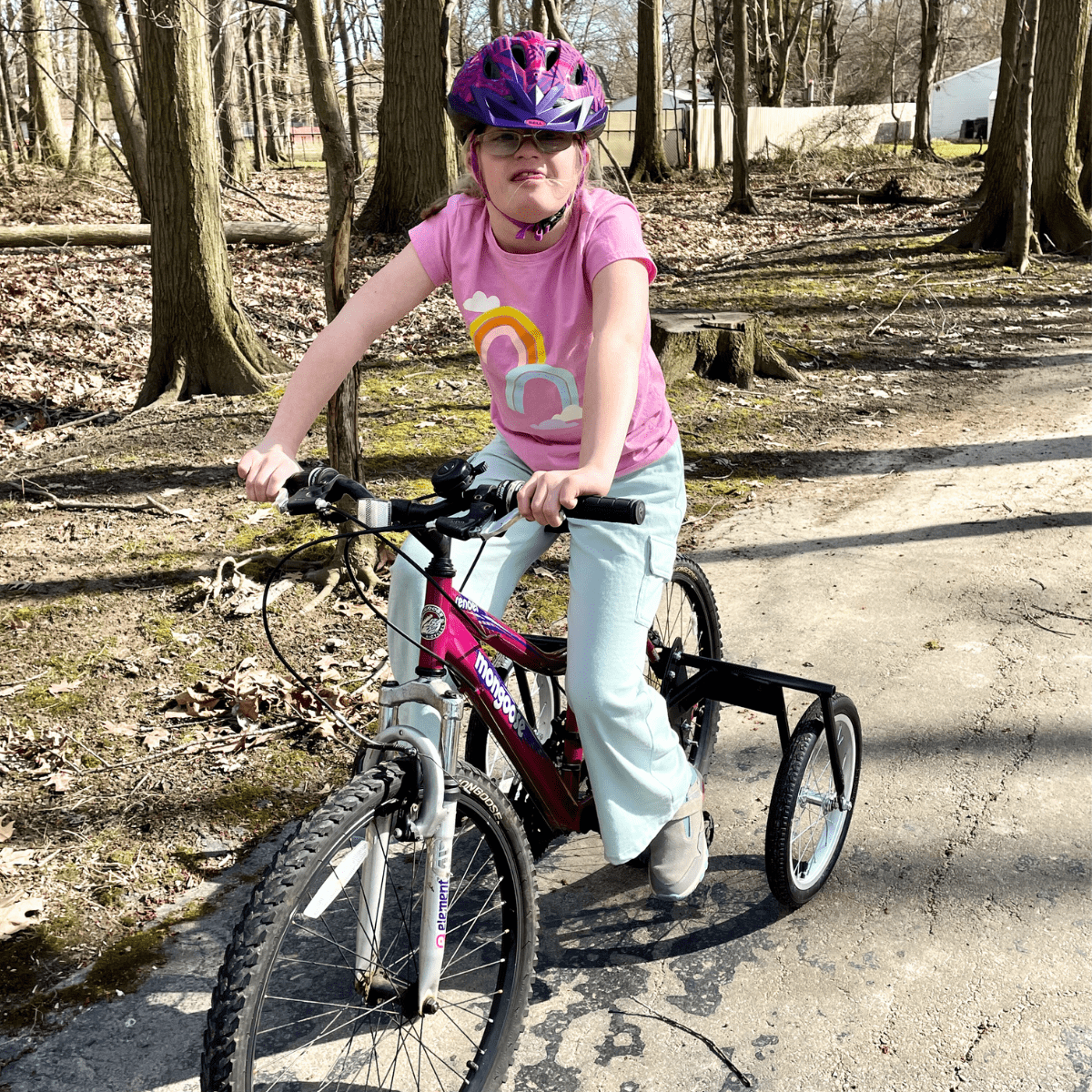 A participant in Rec2Connect's Bike Connect program smiles on her bike. 